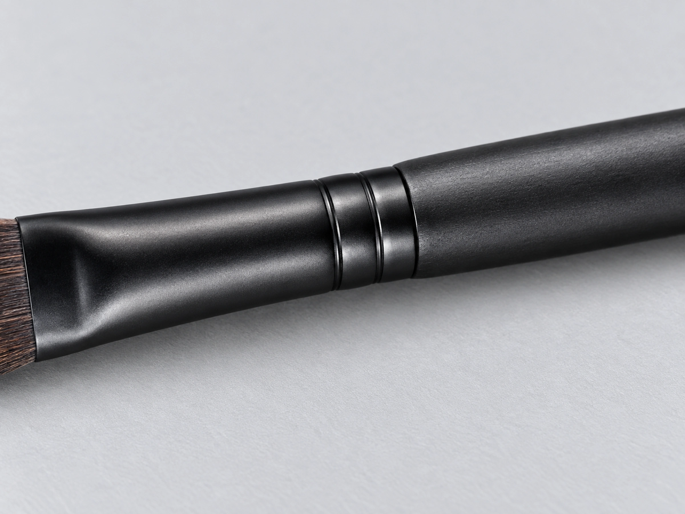 B004 black copper ferrule and engraved collar meeting its matte black solid-wood handle