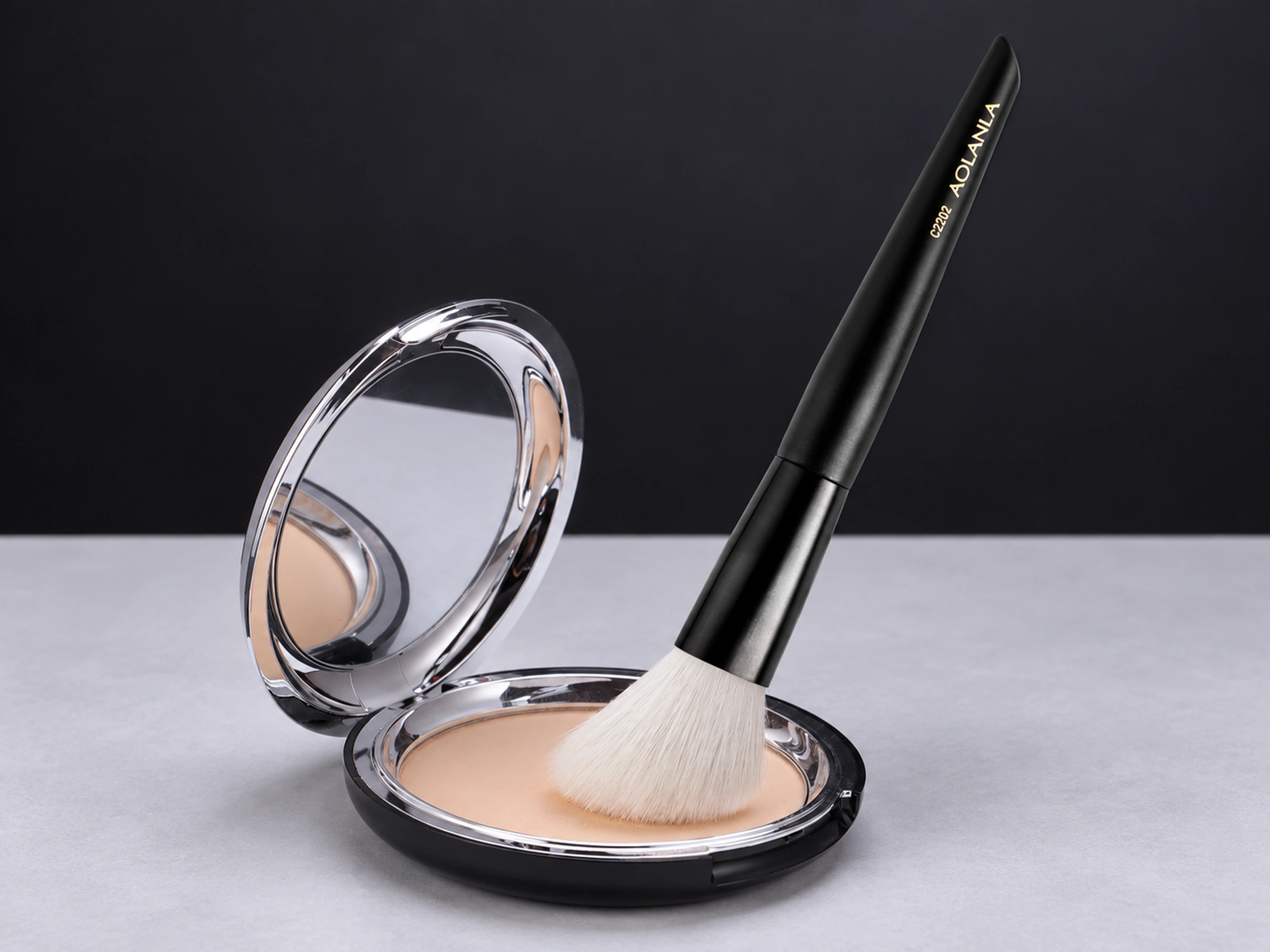 Original C2202 angled contour brush resting in a styling powder compact
