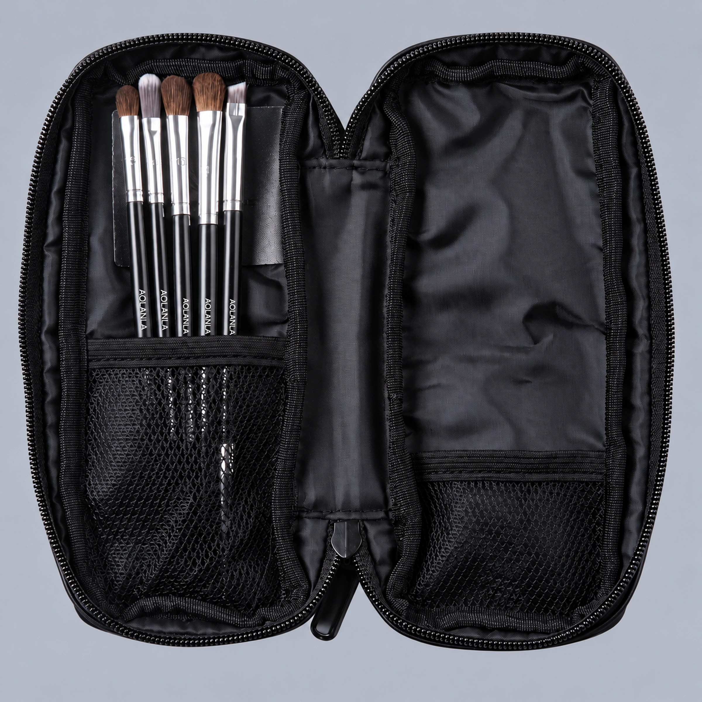 Open black zipper pouch containing the five brushes and mesh compartments