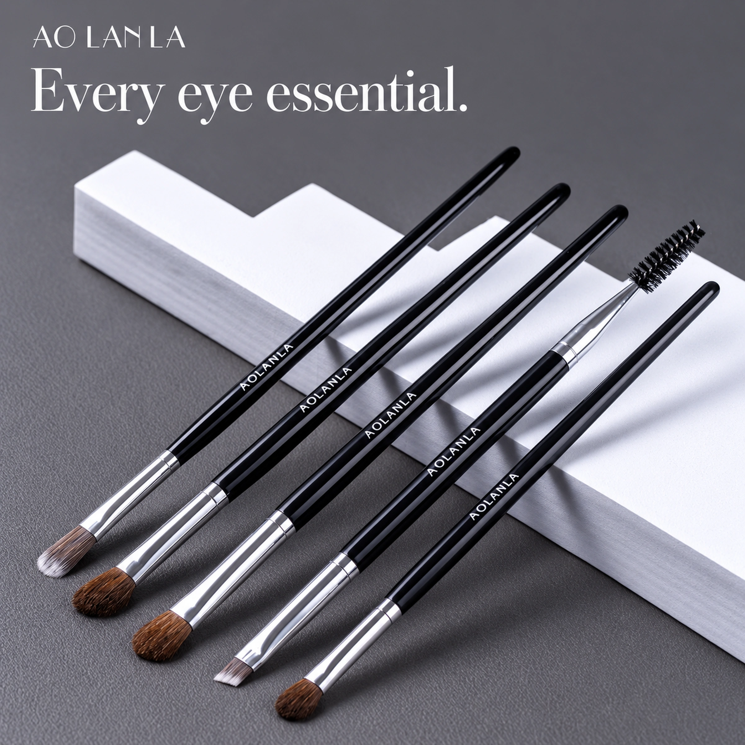 Five complete black-handled brushes in a diagonal silver and black studio arrangement