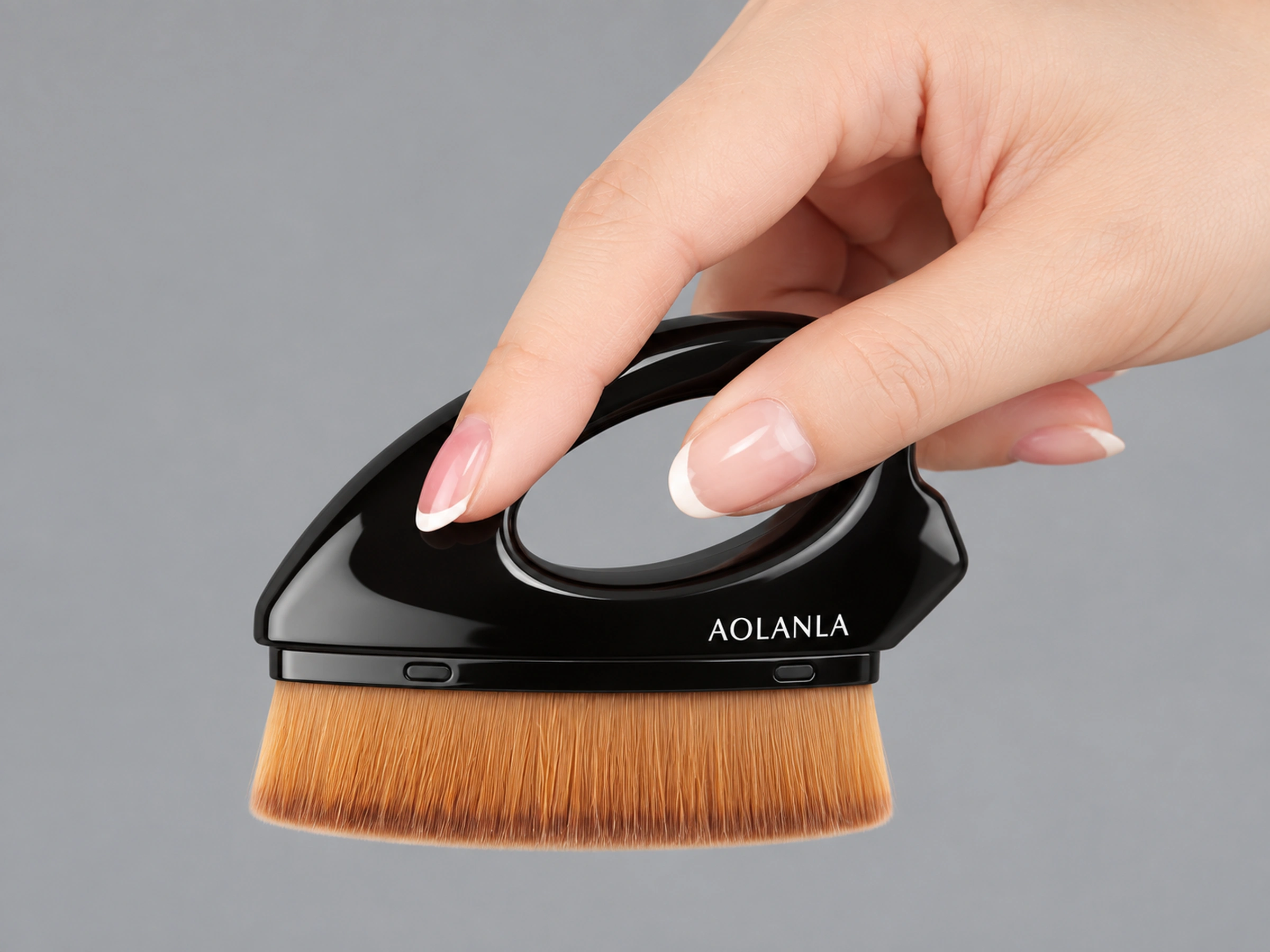 The real glossy black foundation-brush body with its original oval grip, held in one hand