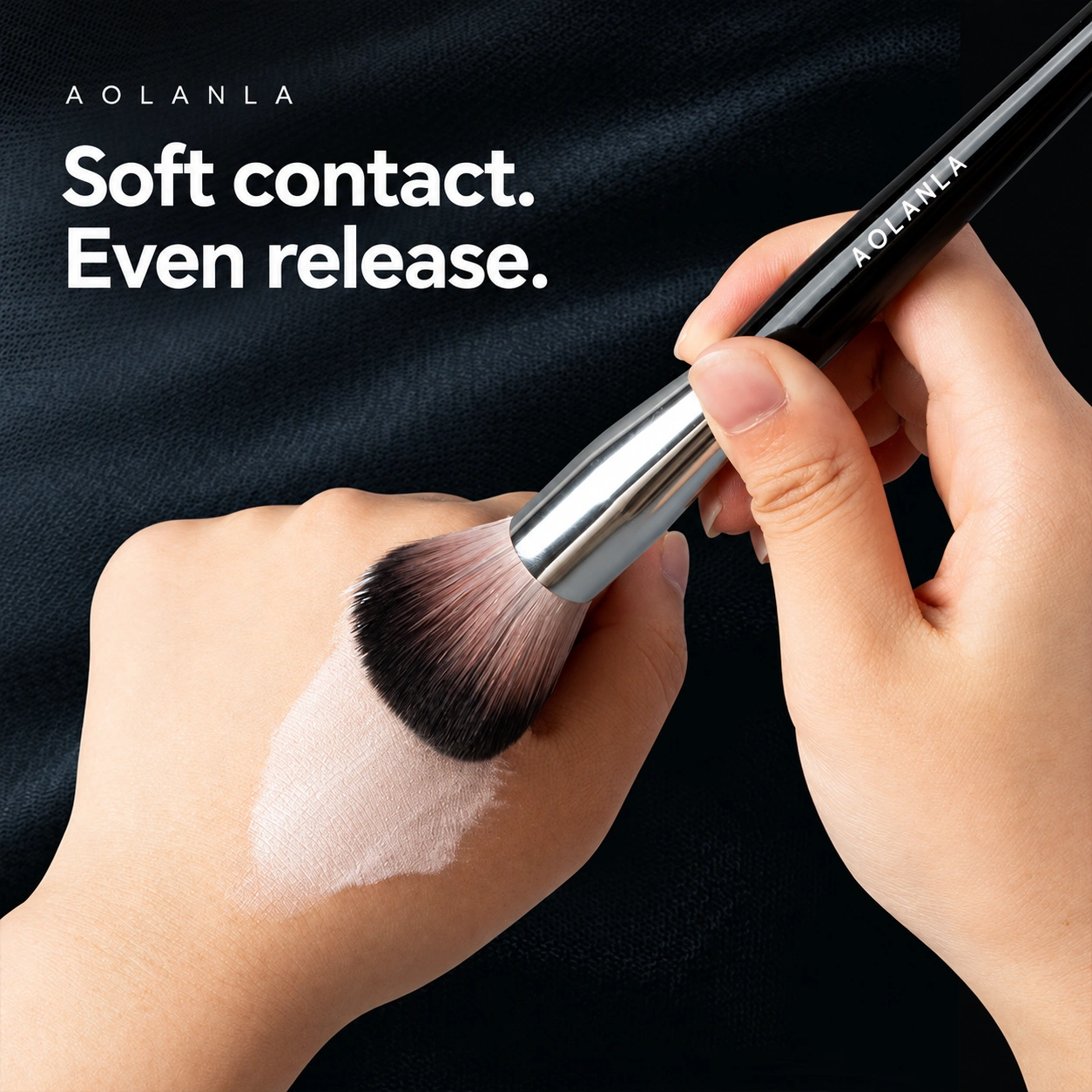 AOLANLA powder brush demonstrating a soft sweep over a powder swatch on the back of a hand