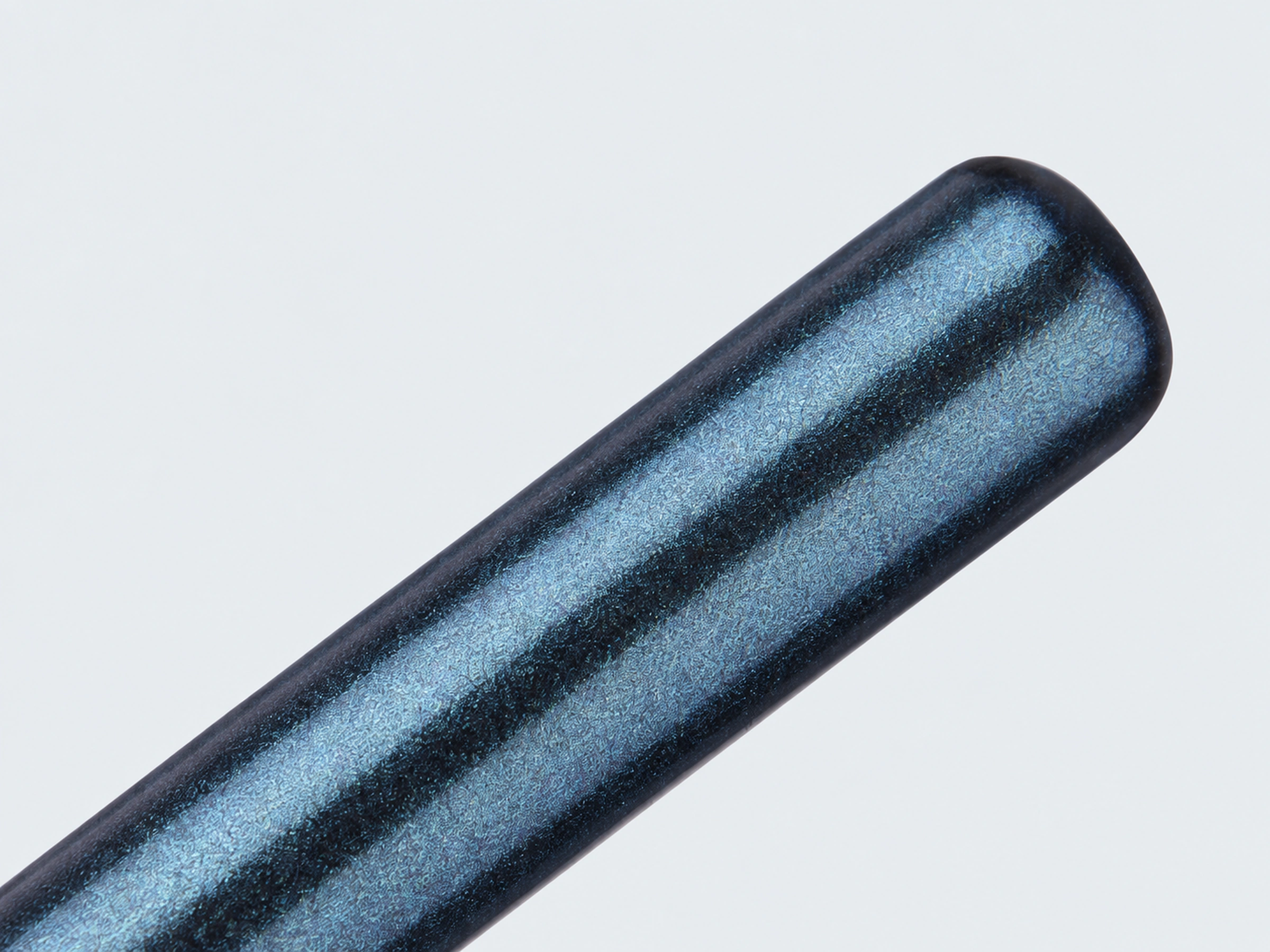 Original smooth rounded end and fine blue pearlescent finish of the wooden grip