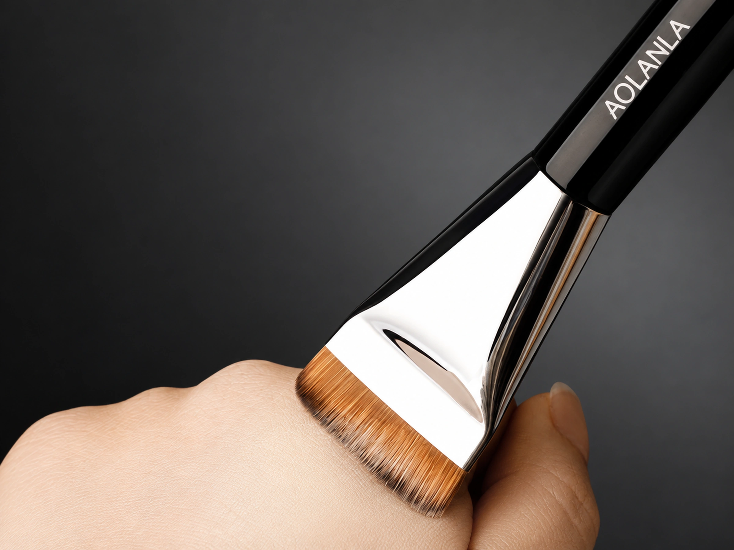 Original flat golden-brown brush head gently touching the back of a hand