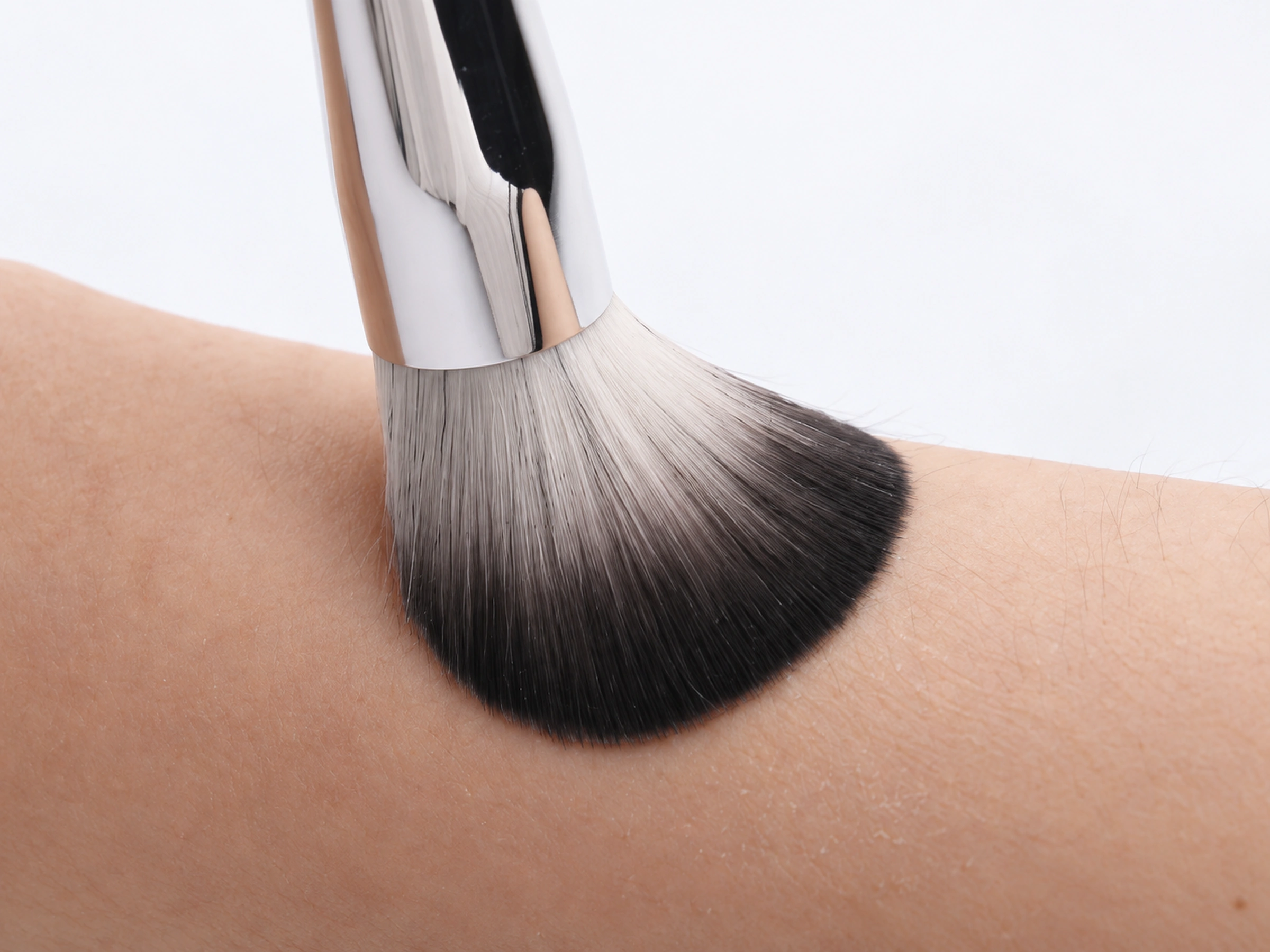 Actual No.90 pale-to-dark synthetic fibres flexing gently against a forearm