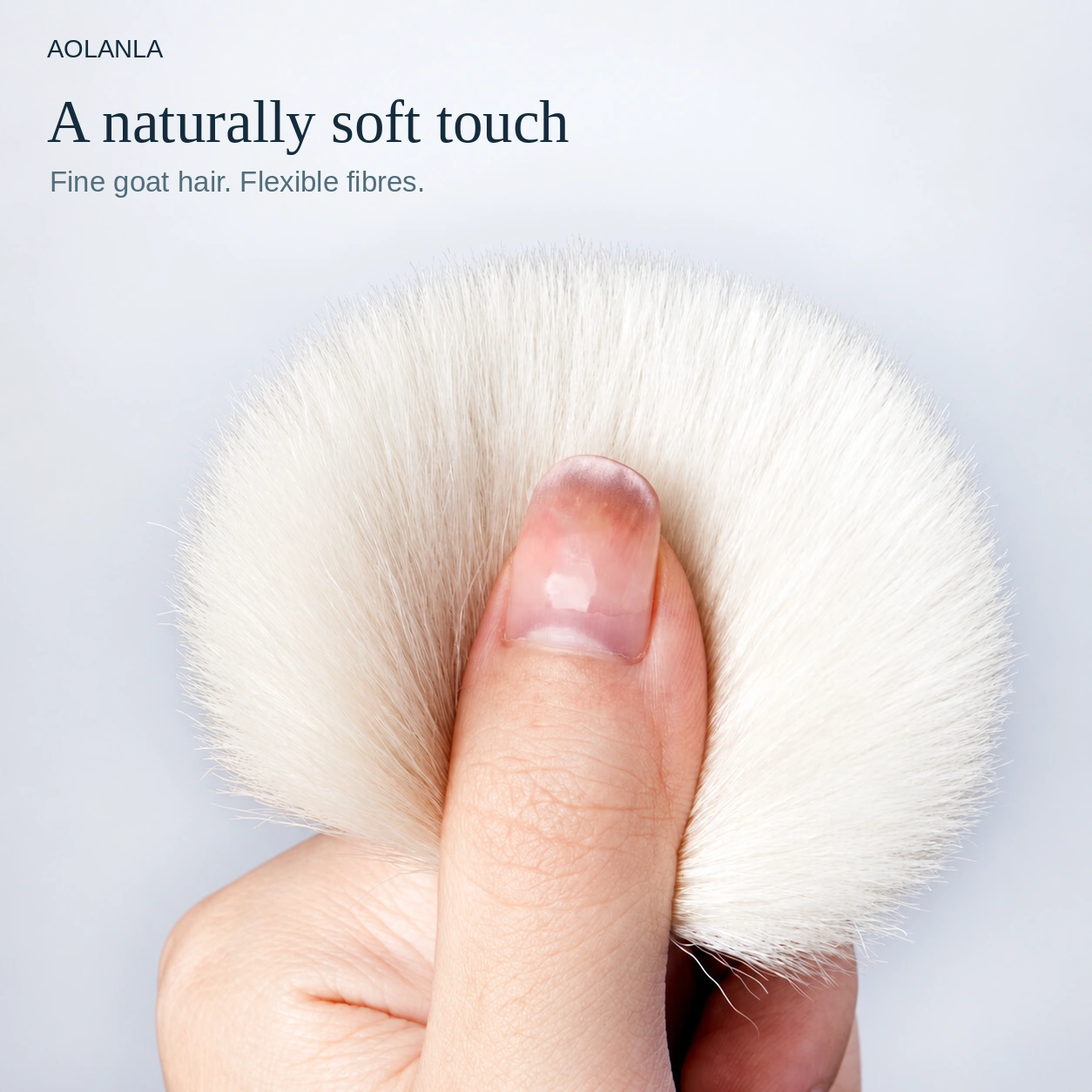 Original ivory goat-hair brush fibres flexing softly around a thumb