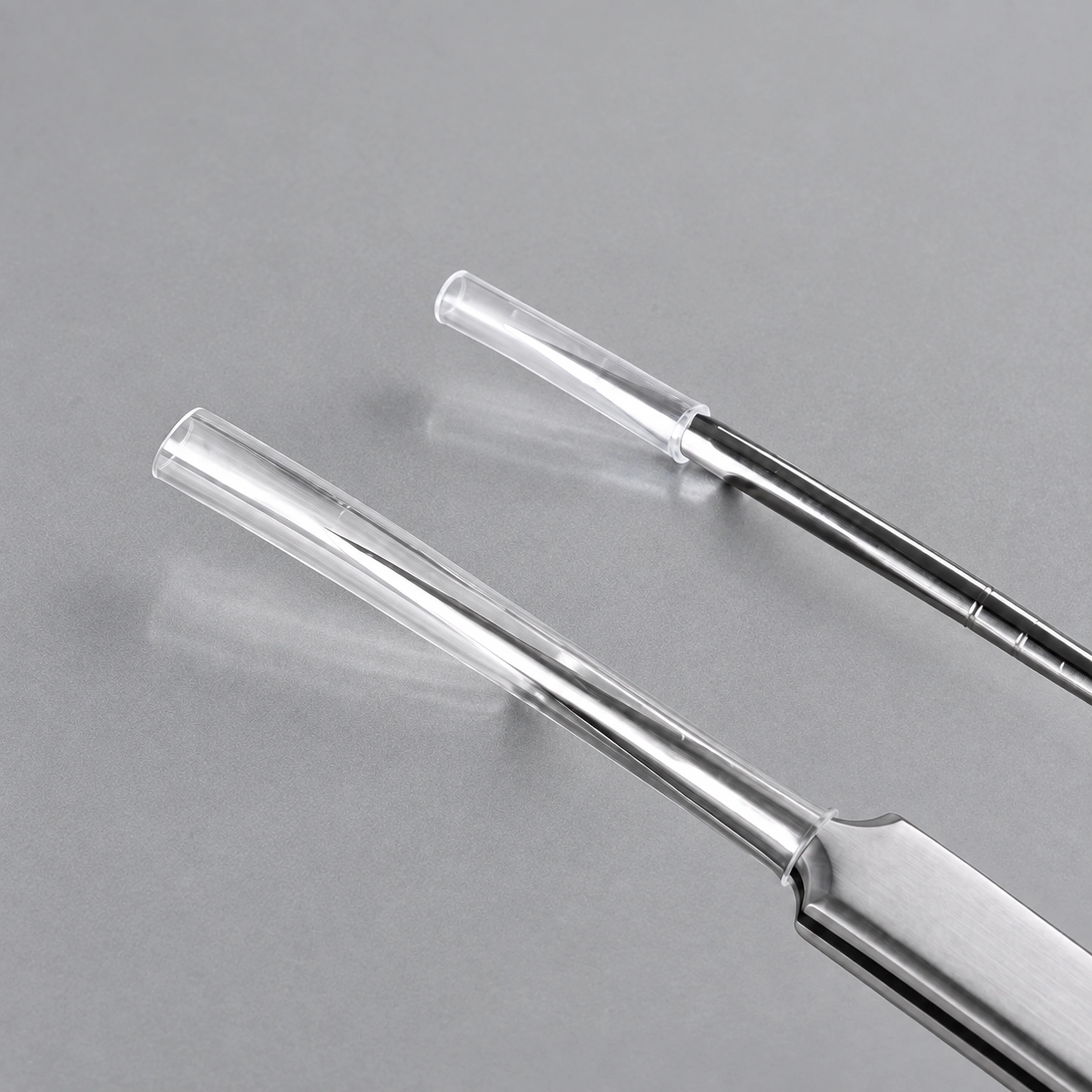 Transparent protective sleeves covering tweezer jaws and needle tip
