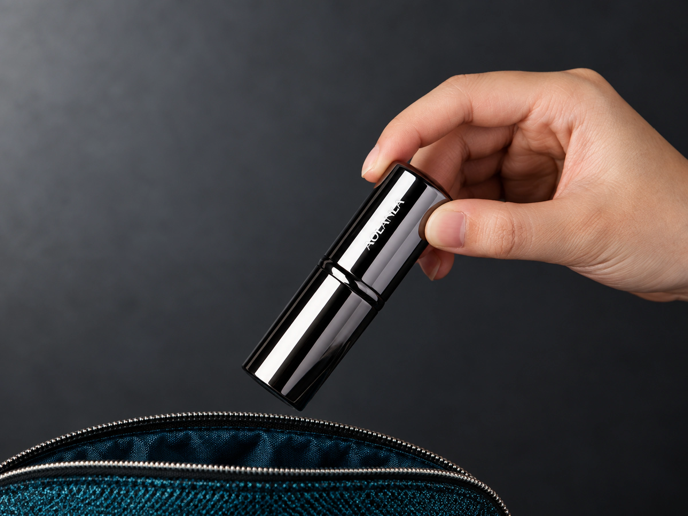 Original closed retractable powder brush held above a styling pouch, pouch not included