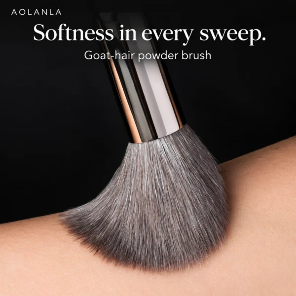 Grey goat-hair powder brush sweeping skin