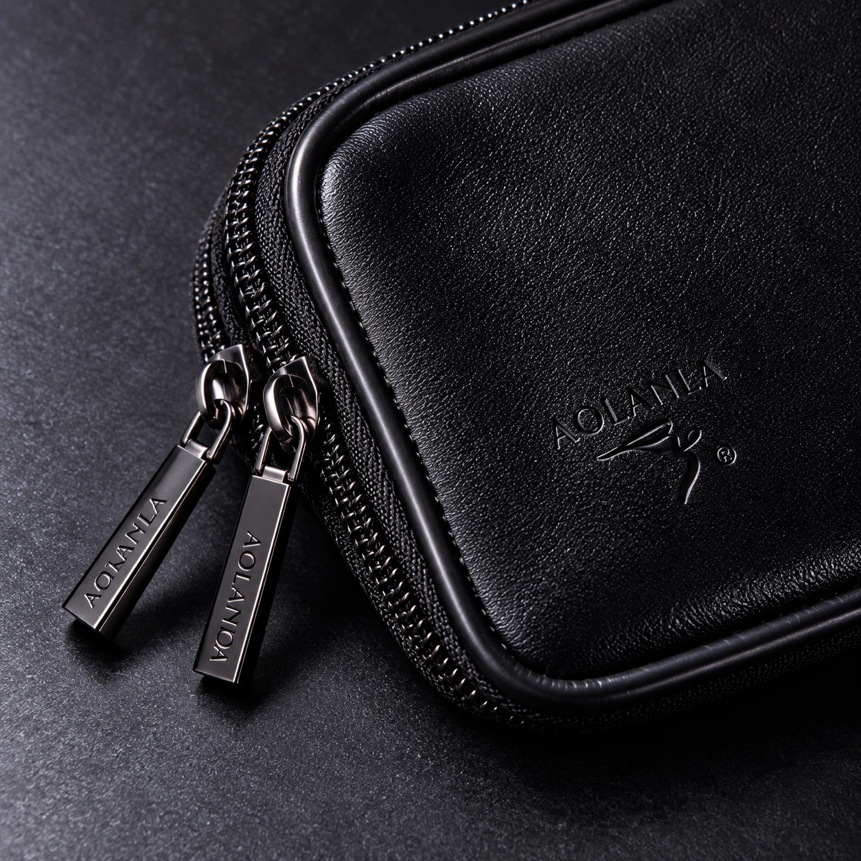 Close-up of the black included Zhumo zip pouch, zipper pulls and stitched edge