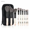 AOLANLA Flower & Bird nine-piece natural hair makeup brush set with black pouch on white background