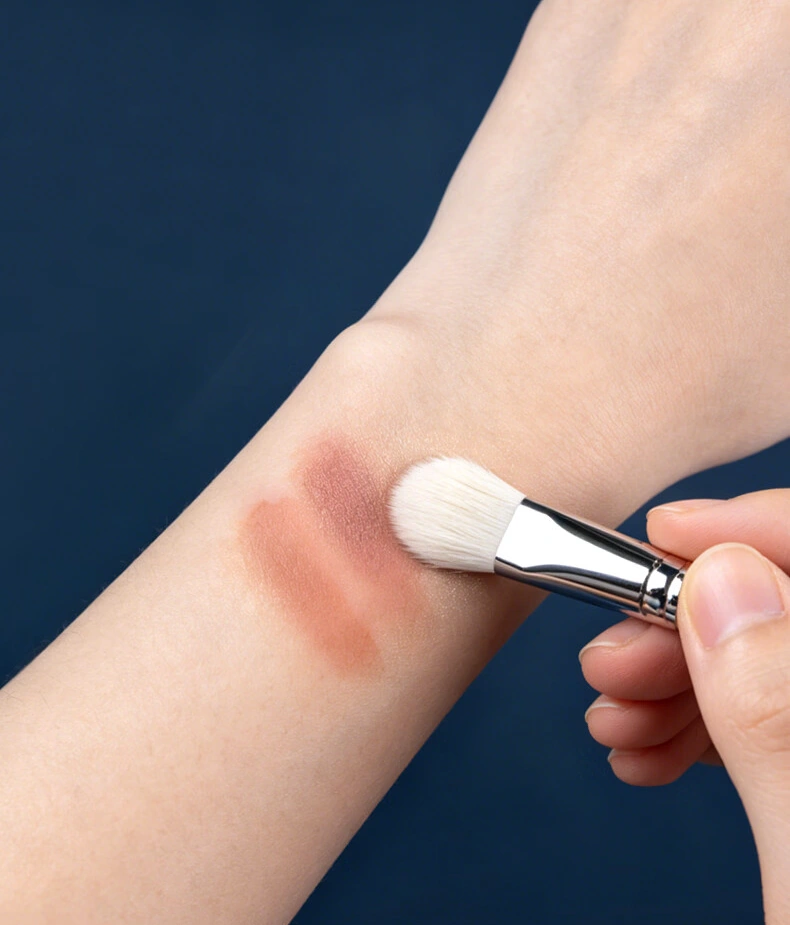 Blue Sakura brush softly blending powder on skin