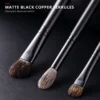Matte-black copper ferrules and dark wood handles with clean joins and balanced control