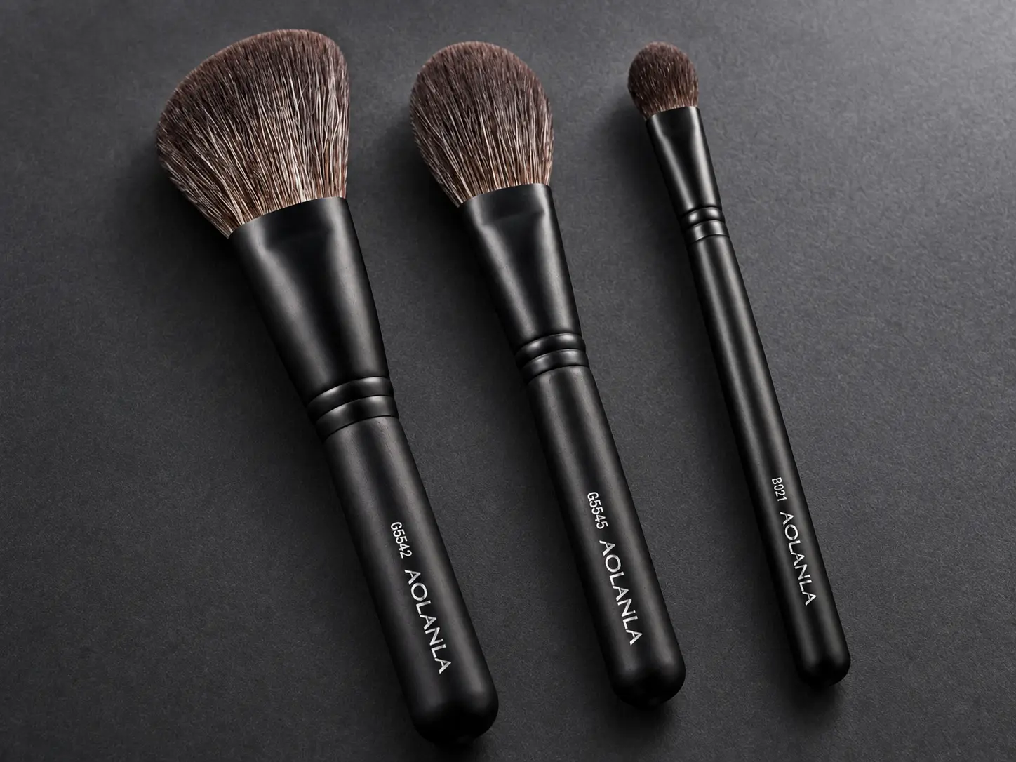 Three AOLANLA matte-black ferrule and dark handle constructions on graphite