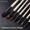 Signature brushes arranged diagonally on a dark textured surface