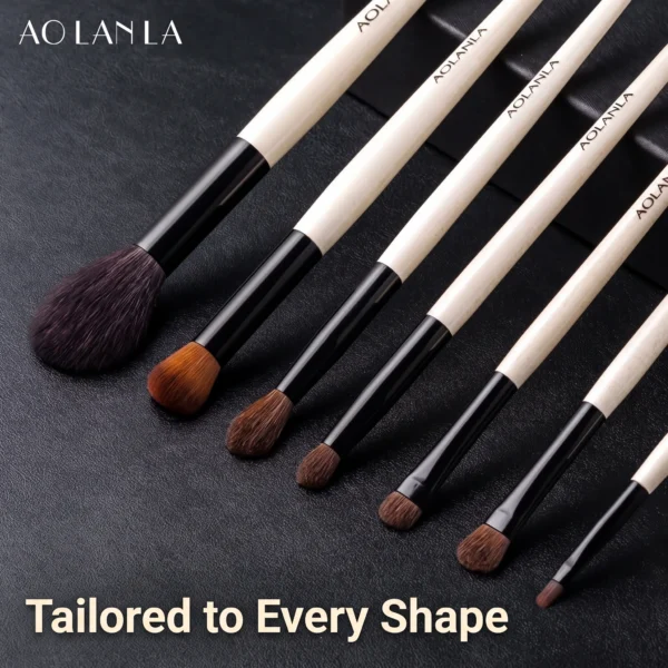 Signature brushes arranged diagonally on a dark textured surface