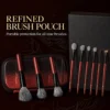 Nine Vermilion Noir brushes with glossy black ferrules, red handles, pouch and gift box